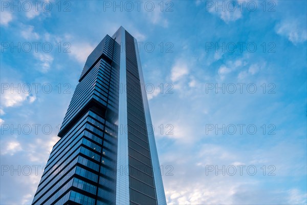Financial area with glass buildings seen from below at sunrise