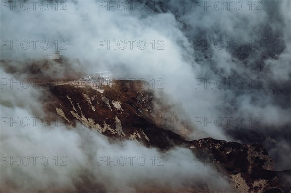 The upper station of the cable lift on Kasprowy Wierch exposed by clouds for a fraction of a second