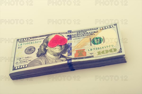 Red hearts and banknote bundle of US dollar