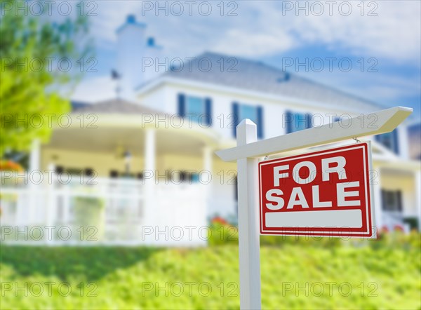 For sale real estate sign in front of new house