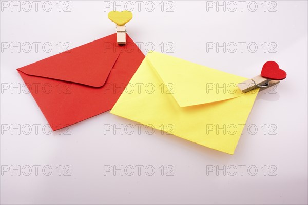 Heart shaped icons on clothespins attached to colorful envelops