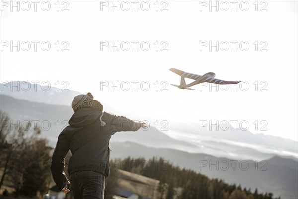 Man playing with model glider