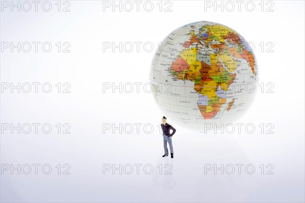 Ittle model globe by the side of man figure