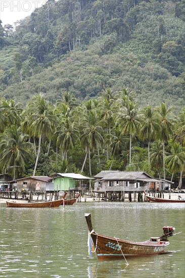 Longtail boat and wooden huts