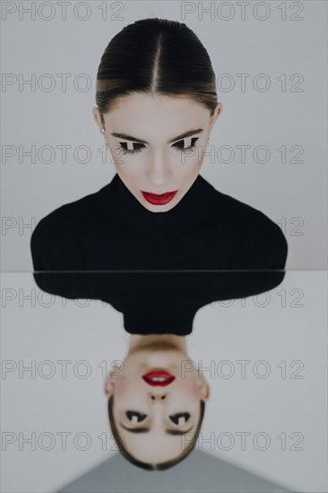 Woman with closed eyes reflected