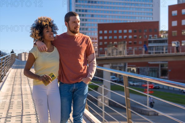 Multiracial couple through the city streets