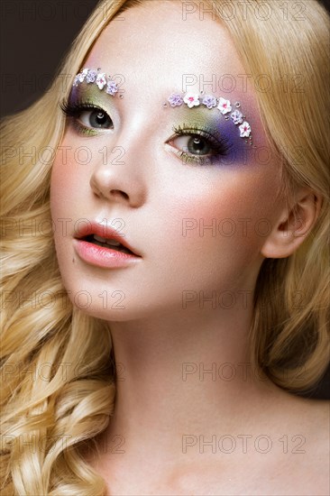 Beautiful young blonde woman with creative make-up color