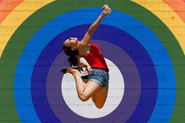 Young woman jumps for joy