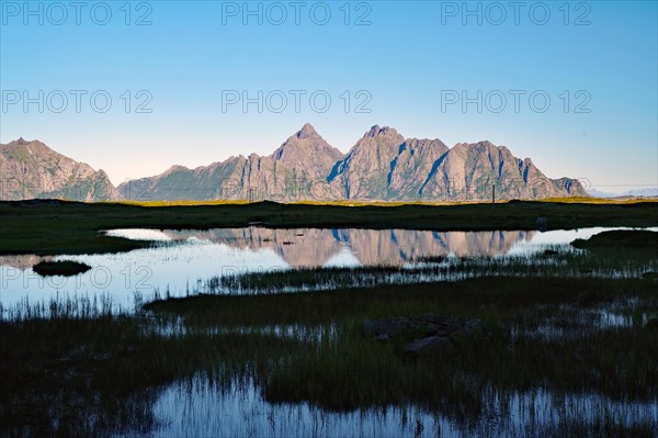 High mountains reflected in the calm waters of a lake