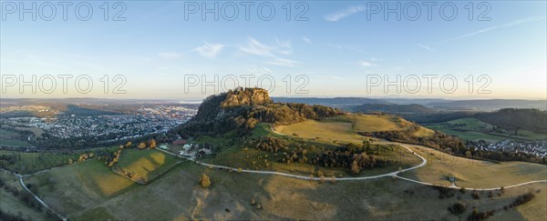 Panorama of the volcanic cone Hohentwiel with the castle ruins illuminated by the evening sun