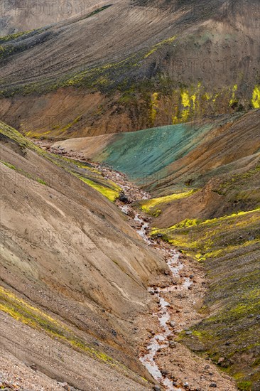 Small river between colourful rhyolite mountains