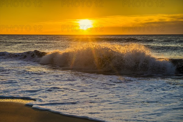 Sunrise with waves on the beach