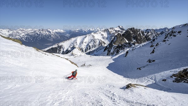 Skiers descending from Pirchkogel in the snow valley