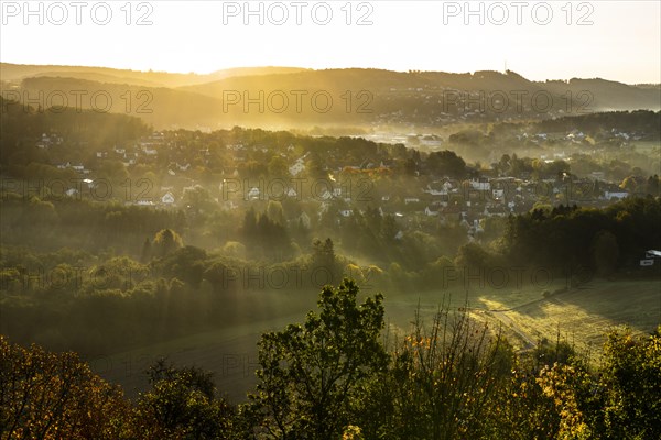 View from the ruins of Windeck Castle to the village of Schladern at sunrise and morning fog