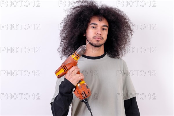 Portrait of the technician with the drill. Young man with afro hair on white background