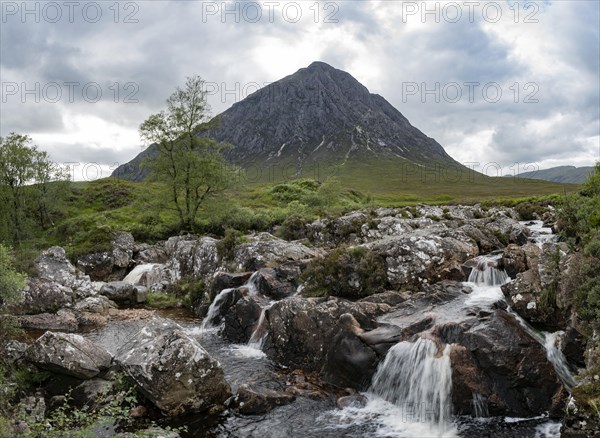 Waterfalls in front of mountain range Buachaille Etive Mor