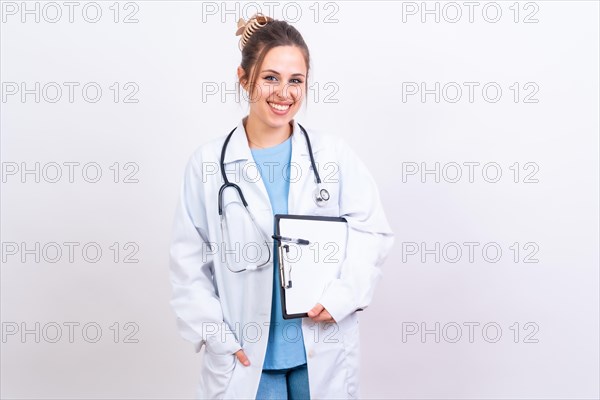 Happy beautiful female doctor in medical coat standing isolated on white