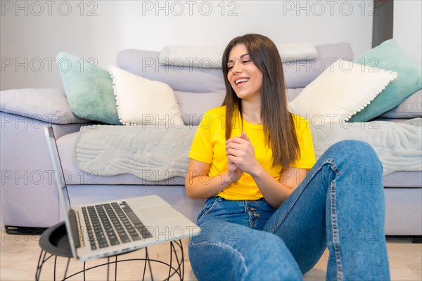 Woman with a computer sitting on a sofa