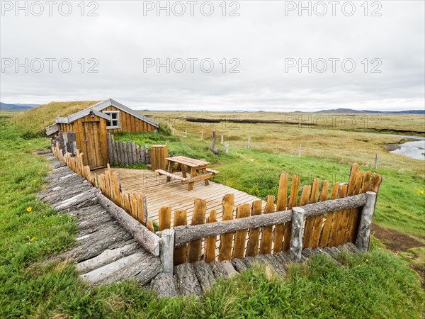 Traditional wooden peat house with grass on the roof