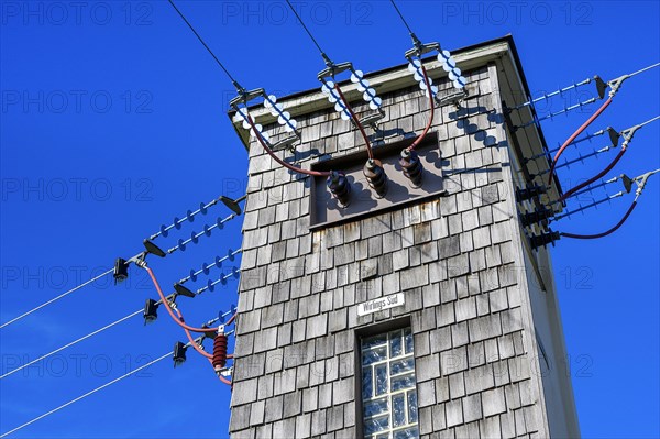 Transformer tower with wooden shingles and ceramic insulators