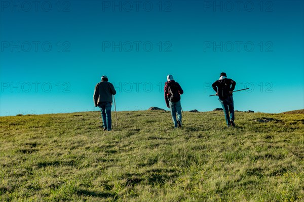 Hikers with backpacks and trekking poles walking in Turkish highland