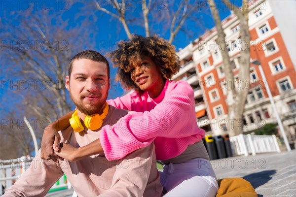 Multiracial couple through the city streets