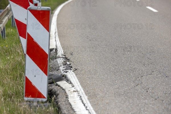 Country road in poor condition with lowered verge