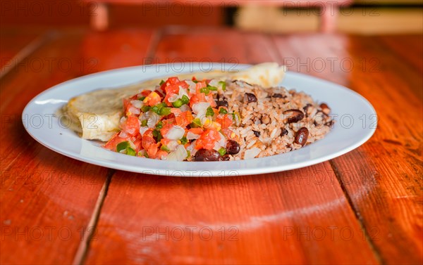 Traditional Gallo Pinto Meal with Pico de Gallo and quesillo served