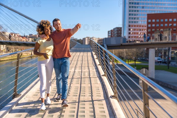 Multiracial couple through the streets of the city