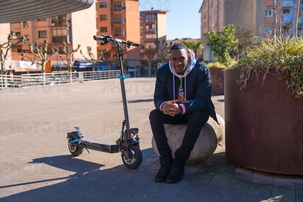 Black ethnic male skateboarding on an electric skate