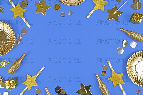 New year border with golden party items on blue background with copy space