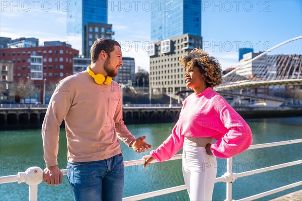 Happy multiracial friends having fun together in the city streets