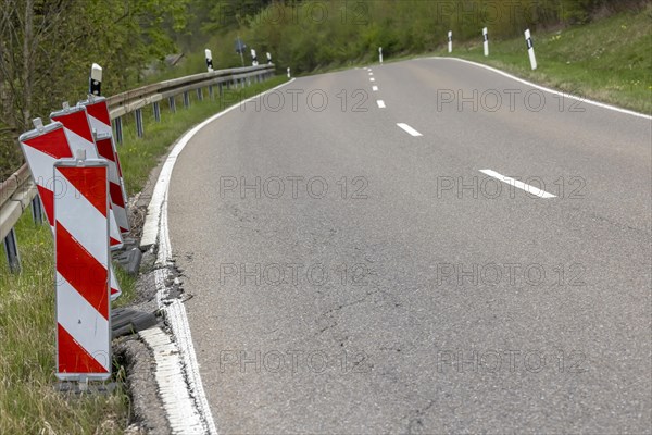 Country road in poor condition with lowered verge