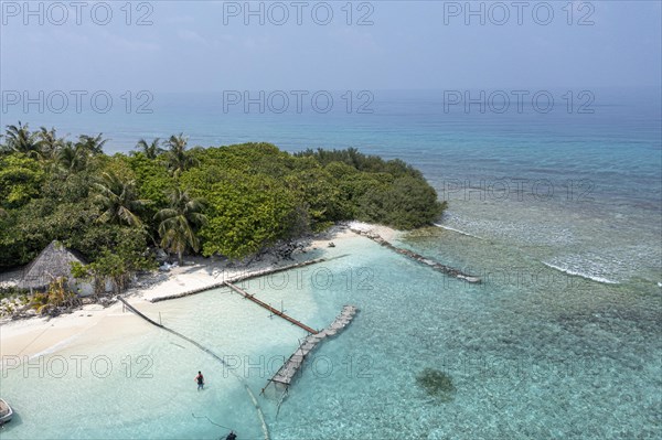 Aerial view: lonely Island with a sandbank and Palmtrees in the Maldives