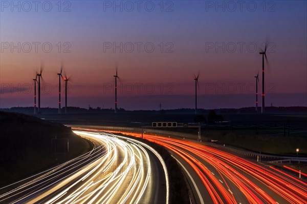 Wind farm with wind turbines in the Swabian Alb in front of sunrise