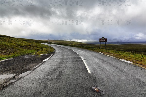 Winding country road in hilly landscape