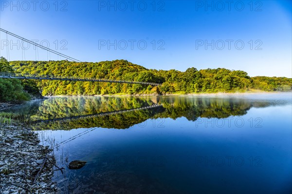 Victor Neels Bridge over Lake Urftsee at sunrise with morning fog