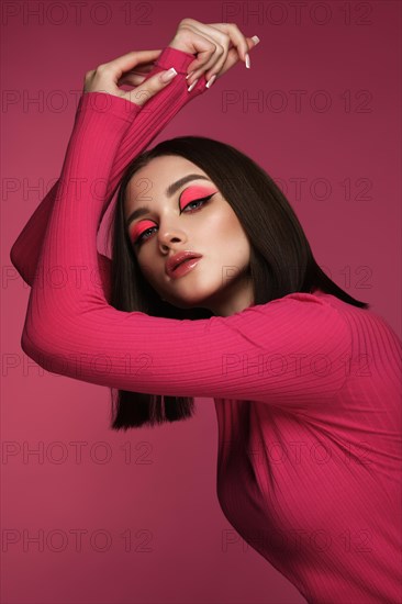 Beautiful brunette woman in pink clothes