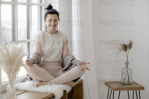 Woman meditating at the window