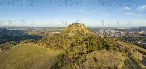 Panorama of the volcanic cone Hohentwiel with the castle ruins illuminated by the evening sun