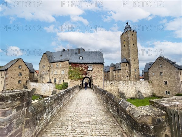 Stone bridge over moat Castle moat from Steinau Castle to small gatehouse right Castle tower Castle tower