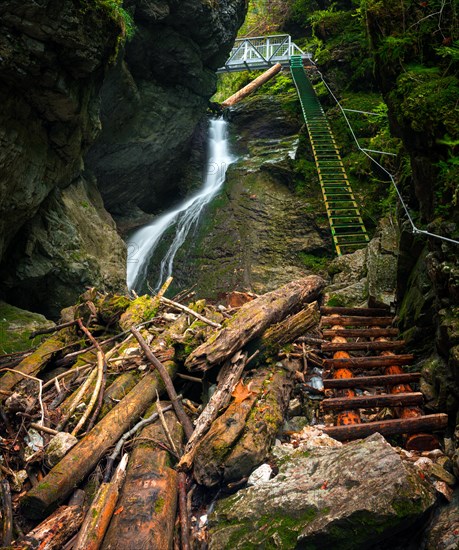 Difficul trail with ladder near the waterfall in canyon of National park Slovak paradise