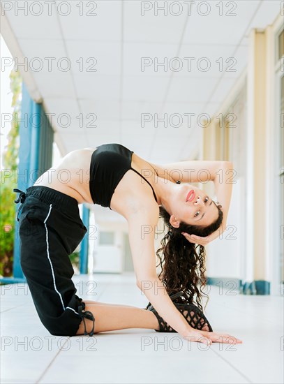 Dance girl doing flexibility in high heels outdoor. Portrait of woman dancer in heels doing yoga flexibilities