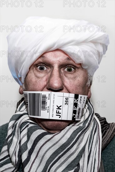 Refugee for repatriation with a flying bandaroleer around his mouth