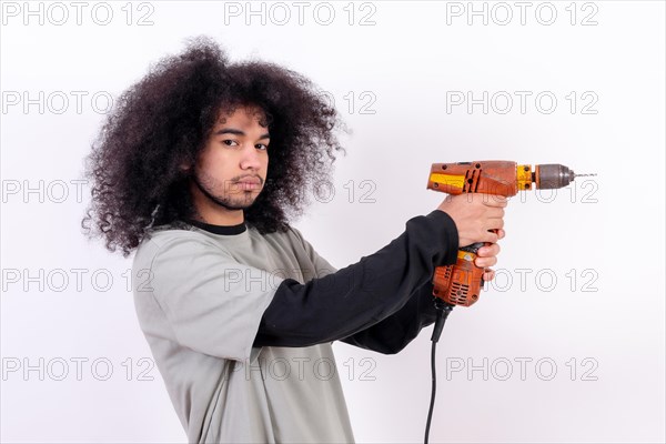 Portrait of the laborer with the drill. Young man with afro hair on white background