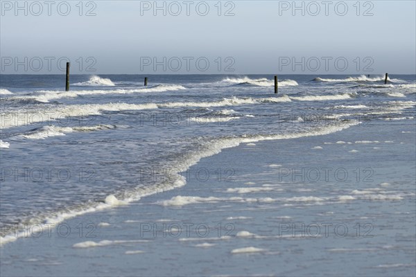 Leaking waves on the North Beach with boundary piles