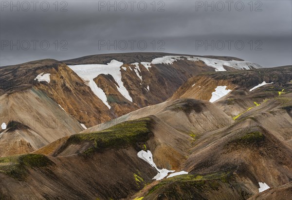 Colourful rhyolite mountains with remnants of snow