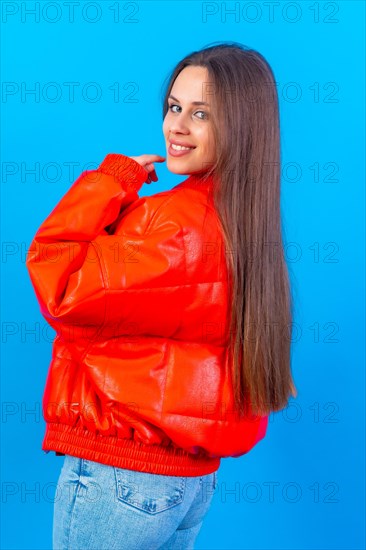 Close up portrait of a young caucasian woman laughing isolated on blue studio background