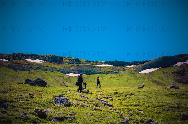 Hikers with backpacks and trekking poles walking in Turkish highland