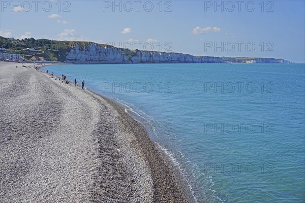 Angler on the shingle beach